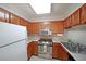 Kitchen with stainless steel appliances, double sink, and oak cabinetry at 1800 Clairmont Lk # A326, Decatur, GA 30033