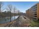 Lake view showing nearby building with balconies and parking in front under clear skies at 1800 Clairmont Lk # A326, Decatur, GA 30033
