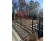 Fenced playground for community children; bordered by black metal fencing and a protective ground cover at 1036 Castanea Dr, Douglasville, GA 30135