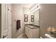 Bathroom with granite countertop vanity, framed mirror and decorative light fixture at 3699 Ashford Creek Ne Hl, Atlanta, GA 30319