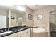 Bathroom featuring double sinks, a soaking tub, and a separate shower at 3699 Ashford Creek Ne Hl, Atlanta, GA 30319