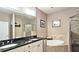 Bathroom with double vanity, soaking tub, and tiled shower at 3699 Ashford Creek Ne Hl, Atlanta, GA 30319