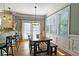 Bright eat-in kitchen featuring windows, access to the patio, and a wood dining table with bench seating at 3699 Ashford Creek Ne Hl, Atlanta, GA 30319