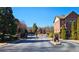 View of a gated community entrance with brick buildings, wrought iron gates and security features in a residential area at 3699 Ashford Creek Ne Hl, Atlanta, GA 30319