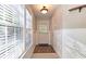 Foyer featuring wainscoting, hardwood floors, and natural light from a window and door at 3699 Ashford Creek Ne Hl, Atlanta, GA 30319