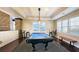 Bright game room features a covered pool table, extra seating, and natural light from multiple windows at 3699 Ashford Creek Ne Hl, Atlanta, GA 30319