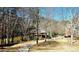 Scenic view of a wooden gazebo near a tranquil lake, accessible by a paved walkway surrounded by trees at 3699 Ashford Creek Ne Hl, Atlanta, GA 30319