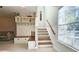 Hallway featuring built-in storage, coat hooks, and carpeted stairs with a wooden railing at 3699 Ashford Creek Ne Hl, Atlanta, GA 30319