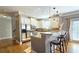 Modern eat-in kitchen with white cabinets, granite countertops, stainless steel appliances, and a breakfast bar at 3699 Ashford Creek Ne Hl, Atlanta, GA 30319