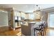 Bright eat-in kitchen featuring stainless appliances, breakfast bar, and an adjacent staircase at 3699 Ashford Creek Ne Hl, Atlanta, GA 30319