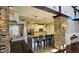 Kitchen with stone accent pillar, stainless steel appliances, a breakfast bar with seating, and modern lighting at 3699 Ashford Creek Ne Hl, Atlanta, GA 30319