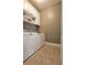 Laundry room with white cabinets and modern appliances, providing functionality and storage at 3699 Ashford Creek Ne Hl, Atlanta, GA 30319