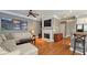 Open-concept living room with hardwood floors, fireplace, and seamless access to the kitchen at 3699 Ashford Creek Ne Hl, Atlanta, GA 30319