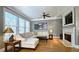 Inviting living room featuring a cozy fireplace, hardwood floors, and large windows at 3699 Ashford Creek Ne Hl, Atlanta, GA 30319