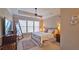Bright main bedroom with large windows, ceiling fan, and tray ceiling at 3699 Ashford Creek Ne Hl, Atlanta, GA 30319