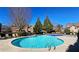Large community pool surrounded by lounge chairs and landscaping, with residential buildings in the background at 3699 Ashford Creek Ne Hl, Atlanta, GA 30319