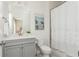 Well-lit bathroom featuring a gray vanity and shower with a lace curtain at 3910 Cameron Ct, Cumming, GA 30040