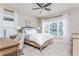 Bedroom featuring white bedding, large windows, a ceiling fan, and a desk at 3910 Cameron Ct, Cumming, GA 30040