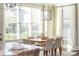 Light-filled dining room with modern chandelier, large windows, and neutral decor at 3910 Cameron Ct, Cumming, GA 30040