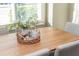 Close up of dining table with seating for six, a centerpiece, and natural light streaming in at 3910 Cameron Ct, Cumming, GA 30040