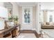 Inviting foyer with hardwood floors, a stylish console table, and a bright view to the front door at 3910 Cameron Ct, Cumming, GA 30040