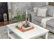 Stylishly decorated coffee table in front of a comfortable gray couch and fireplace at 3910 Cameron Ct, Cumming, GA 30040