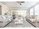 Bright living room with neutral tones, complemented by an open floor plan and ceiling fan at 3910 Cameron Ct, Cumming, GA 30040