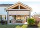 Rear view of a covered patio featuring wicker seating and an elegant wood ceiling at 3910 Cameron Ct, Cumming, GA 30040