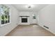 Living room with a brick fireplace, large window, and wood-look floors at 138 Regal Nw Way, Lawrenceville, GA 30044