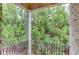 Outdoor balcony with a black metal railing overlooking lush greenery at 2400 Weber Heights Way, Buford, GA 30519