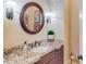 Stylish bathroom features a granite countertop, dark wood vanity, and decorative mirror at 2400 Weber Heights Way, Buford, GA 30519