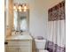 Tastefully decorated bathroom with a granite countertop, vanity, and unique shower curtain at 2400 Weber Heights Way, Buford, GA 30519
