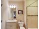 Bathroom featuring a shower/tub combo, a vanity with sink and a framed mirror at 2400 Weber Heights Way, Buford, GA 30519