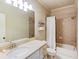 Well-lit bathroom with a single sink vanity and a shower/tub combination at 2400 Weber Heights Way, Buford, GA 30519