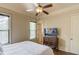 Cozy bedroom features hardwood floors, natural light, and a ceiling fan at 2400 Weber Heights Way, Buford, GA 30519