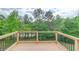 Deck overlooking wooded area with deck railing. Lots of trees at 2400 Weber Heights Way, Buford, GA 30519