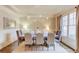 Elegant dining room featuring a stylish chandelier, wainscoting, and ample natural light at 2400 Weber Heights Way, Buford, GA 30519