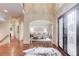 Inviting foyer with hardwood floors, views to formal dining, and decorative iron front doors at 2400 Weber Heights Way, Buford, GA 30519
