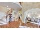 Spacious foyer featuring hardwood floors, an elegant staircase, and views to the formal dining area at 2400 Weber Heights Way, Buford, GA 30519