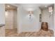 Hallway with rustic charm with unique lighting fixtures and barrel decoration with painted brick in the background at 2400 Weber Heights Way, Buford, GA 30519