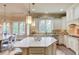 Gourmet kitchen features a center island, stainless steel appliances, and a breakfast nook with backyard views at 2400 Weber Heights Way, Buford, GA 30519