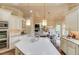 The kitchen showcases a large center island, stainless steel appliances, and views to dining room at 2400 Weber Heights Way, Buford, GA 30519