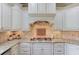 Charming kitchen featuring a granite countertop, custom cabinets, and tile backsplash at 2400 Weber Heights Way, Buford, GA 30519