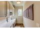 Well-lit laundry room with ample counter space, modern appliances, wooden floors and decorative wall art at 2400 Weber Heights Way, Buford, GA 30519