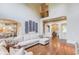 Open living area with hardwood floors, exposed archways, and a large comfortable sofa at 2400 Weber Heights Way, Buford, GA 30519