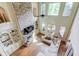 Bright living room with a stone fireplace, built-in bookshelves, and expansive windows at 2400 Weber Heights Way, Buford, GA 30519