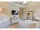 Comfortable bedroom featuring a tray ceiling, TV, and a dresser with decorative accents at 2400 Weber Heights Way, Buford, GA 30519