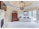 Well-appointed main bedroom with a sitting area, fireplace, and access to a private balcony at 2400 Weber Heights Way, Buford, GA 30519