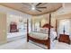 Spacious main bedroom with a sitting area, four-poster bed, and custom ceiling at 2400 Weber Heights Way, Buford, GA 30519