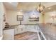 Charming wet bar with a farmhouse sink, stone counters, white cabinets and shelving at 2400 Weber Heights Way, Buford, GA 30519